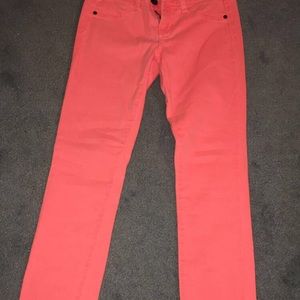 Bright salmon colored skinny jeans